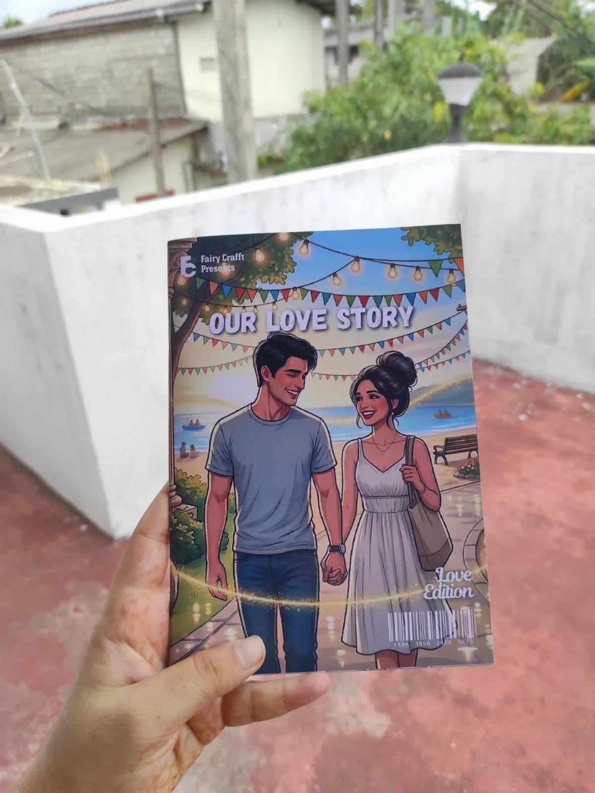 Hand holding a personalized love story book with a couple illustration on cover