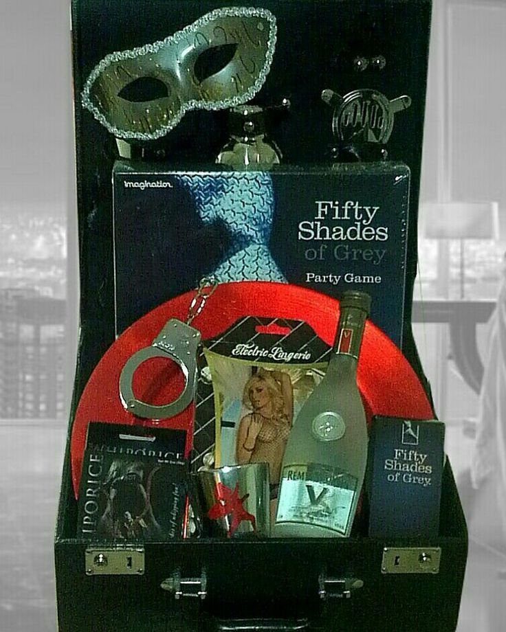 Adult-themed gift set in a black suitcase with a bottle and party game.