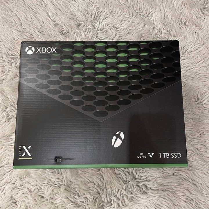 Xbox Series X console box on a white fluffy faux-fur rug